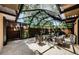 Enclosed patio featuring comfortable seating, a fire pit, and views of lush greenery at 2706 11Th Ct, Palm Harbor, FL 34684