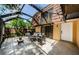 Enclosed patio with tile flooring, stylish furniture, and a cozy fire pit at 2706 11Th Ct, Palm Harbor, FL 34684
