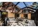 Enclosed patio area with tile flooring, outdoor seating, and access to the home at 2706 11Th Ct, Palm Harbor, FL 34684