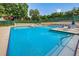 Large community swimming pool with lounge chairs and shade umbrellas ready for residents to enjoy at 2706 11Th Ct, Palm Harbor, FL 34684