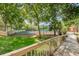 A community tennis court is surrounded by lush greenery, and can be accessed from a wooden walkway at 2706 11Th Ct, Palm Harbor, FL 34684