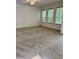 Spacious bedroom featuring neutral carpet, ceiling fan, and three windows with wooded views at 27653 Pleasure Ride Loop, Wesley Chapel, FL 33544