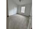 Bedroom featuring neutral carpet, window with blinds and closet with bi-fold doors at 27653 Pleasure Ride Loop, Wesley Chapel, FL 33544