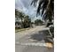 View of the gated entrance to the community, promising security and privacy with lush tropical landscaping at 27653 Pleasure Ride Loop, Wesley Chapel, FL 33544