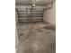 An empty two car garage with a concrete floor, overhead door, and garage door opener at 27653 Pleasure Ride Loop, Wesley Chapel, FL 33544