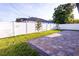 Fully fenced backyard featuring a brick paver patio, grassy area, and privacy fence at 3002 W Abdella St, Tampa, FL 33607