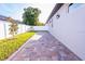 Well-manicured backyard showcasing a brick patio and white privacy fence at 3002 W Abdella St, Tampa, FL 33607