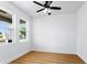 Well-lit bedroom with wood floors, neutral walls, and a ceiling fan for added comfort at 3002 W Abdella St, Tampa, FL 33607