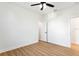 Bright and airy bedroom with wood floors, neutral walls, a ceiling fan, and ample closet space at 3002 W Abdella St, Tampa, FL 33607
