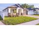Charming single-story home featuring a well-manicured lawn and a private driveway leading to an attached garage at 3002 W Abdella St, Tampa, FL 33607