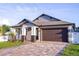 Attractive home with a two-car garage and a paved driveway leading to a covered front porch with elegant columns at 3002 W Abdella St, Tampa, FL 33607