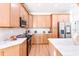 Modern kitchen with light wood cabinets, stainless steel appliances, and marble countertops offering ample counter space at 3002 W Abdella St, Tampa, FL 33607