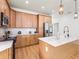 Well-lit kitchen with stainless steel appliances, light wood cabinetry, marble countertops, and an island with seating at 3002 W Abdella St, Tampa, FL 33607