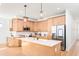 Bright, open kitchen featuring light wood cabinets, stainless appliances, and a center island with a marble countertop at 3002 W Abdella St, Tampa, FL 33607