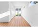 Bright living room featuring wood floors, white walls, and sliding glass doors to the backyard at 3002 W Abdella St, Tampa, FL 33607