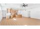 Open-concept living space featuring wood flooring, light cabinetry, and a built-in bar area connecting to the kitchen at 3002 W Abdella St, Tampa, FL 33607