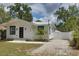 Charming home with a well-maintained lawn and gravel driveway at 3008 E 38Th Ave, Tampa, FL 33610