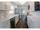 Bright kitchen featuring white cabinets, modern appliances, and sleek countertops at 3008 E 38Th Ave, Tampa, FL 33610