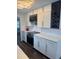 A beautifully designed kitchen features white cabinetry, a wine rack, and stainless steel appliances at 3008 E 38Th Ave, Tampa, FL 33610