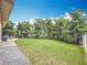 Expansive backyard featuring lush lawn, mature trees, and patio area for outdoor enjoyment at 3093 Hillside Ln, Safety Harbor, FL 34695