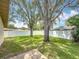 Spacious backyard with well-maintained lawn, surrounded by a pristine white fence and mature trees at 3093 Hillside Ln, Safety Harbor, FL 34695