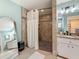Bathroom featuring a shower, decorative mirror, and granite double vanity at 3093 Hillside Ln, Safety Harbor, FL 34695