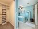 Bathroom featuring a closet, bathtub, decorative mirror and blue accent wall at 3093 Hillside Ln, Safety Harbor, FL 34695