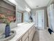 Bathroom featuring a shower, double vanity, decorative plant, and tile floors at 3093 Hillside Ln, Safety Harbor, FL 34695