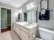 Bathroom featuring a single vanity, toilet, linen closet and tile floors at 3093 Hillside Ln, Safety Harbor, FL 34695