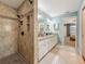 Bathroom featuring a shower, granite double vanity and entrance to bedroom at 3093 Hillside Ln, Safety Harbor, FL 34695