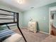 Bedroom showcasing a bunk bed, light-green walls, carpeted floor, and a white secretary desk at 3093 Hillside Ln, Safety Harbor, FL 34695