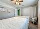 Bedroom showcasing soft carpet, feather accent wall, white bed, closet, and blue accent chair at 3093 Hillside Ln, Safety Harbor, FL 34695