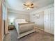 Bedroom featuring a white bed, nightstand, pink curtains, ceiling fan, and a light paint scheme at 3093 Hillside Ln, Safety Harbor, FL 34695
