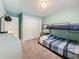 Bedroom with a bunk bed, light-green walls, carpeted floor, and a sliding-door closet at 3093 Hillside Ln, Safety Harbor, FL 34695