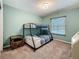 Bedroom with a bunk bed, light-green walls, window view of pool, and a wooden side table at 3093 Hillside Ln, Safety Harbor, FL 34695