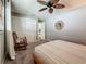 Bedroom features a queen bed, rocking chair, closet and ceiling fan at 3093 Hillside Ln, Safety Harbor, FL 34695