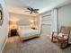 Bedroom features a queen bed, ceiling fan, rocking chair, and carpeted floors at 3093 Hillside Ln, Safety Harbor, FL 34695