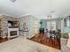 Open dining area with hardwood floors, stylish lighting, and easy access to the kitchen and living room at 3093 Hillside Ln, Safety Harbor, FL 34695