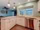 Bright kitchen features granite countertops, stainless steel appliances, and white cabinetry at 3093 Hillside Ln, Safety Harbor, FL 34695
