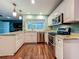 Modern kitchen features white cabinets, granite countertops, stainless steel appliances, and ample natural light at 3093 Hillside Ln, Safety Harbor, FL 34695