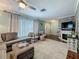 Cozy living room features a plush sectional, decorative brick wall, and plenty of natural light at 3093 Hillside Ln, Safety Harbor, FL 34695