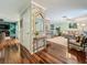 Open-concept living room with hardwood floors, brick accent wall, and ample natural light at 3093 Hillside Ln, Safety Harbor, FL 34695