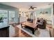 Spacious living room with wood floors, modern furnishings, and a view into the kitchen at 3093 Hillside Ln, Safety Harbor, FL 34695