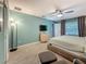 Comfortable main bedroom with a ceiling fan, soft lighting, and ample closet space at 3093 Hillside Ln, Safety Harbor, FL 34695