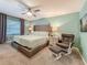 Spacious main bedroom with a comfortable bed, soft lighting, and a cozy seating area at 3093 Hillside Ln, Safety Harbor, FL 34695
