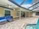 This outdoor space boasts a pool, lanai seating, and a dining area, perfect for relaxation and entertaining at 3093 Hillside Ln, Safety Harbor, FL 34695