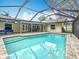 Screened-in pool featuring steps and a beautiful view of the outdoor patio and backyard at 3093 Hillside Ln, Safety Harbor, FL 34695