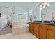 The bathroom includes a soaking tub, a double vanity, and shuttered windows, creating a spa-like atmosphere at 378 Wood Chuck Ave, Tarpon Springs, FL 34689