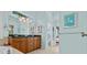 Bathroom features a double vanity, an art piece, a large mirror and a walk-in shower, offering luxury at 378 Wood Chuck Ave, Tarpon Springs, FL 34689