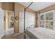 Bright bedroom with a four poster bed and plantation shutters for ample natural light at 378 Wood Chuck Ave, Tarpon Springs, FL 34689